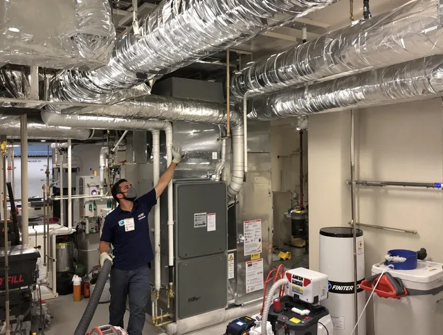 Clinton Air Duct Cleaning specialist performing thorough furnace duct cleaning in a Clinton residence