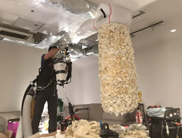 Clinton Air Duct Cleaning technician performing precision vacuum insulation removal in a residential property in Clinton